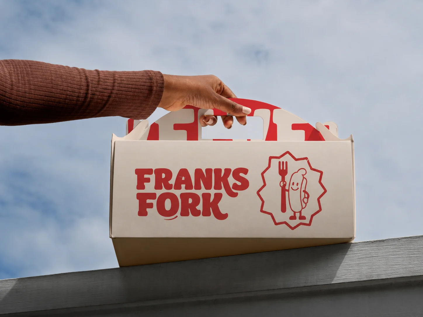 Franks Fork cream takeaway box with the red wordmark and scalloped EST. 2024 seal