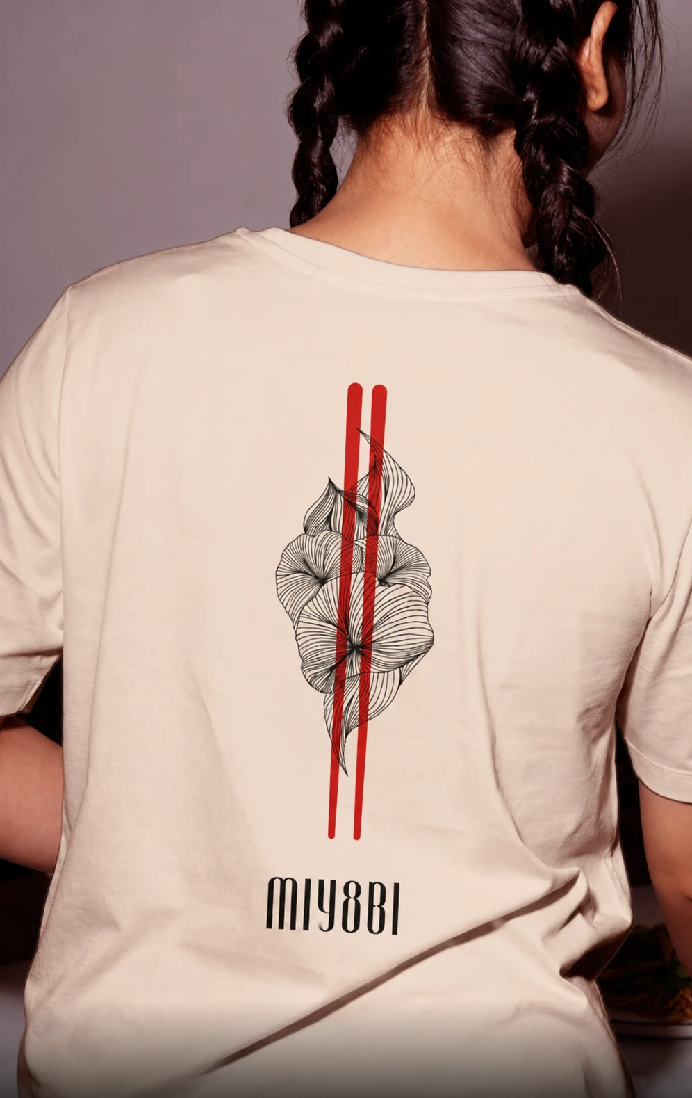 Cream Miyabi t-shirt, back view, with the camellia emblem and red chopstick lines