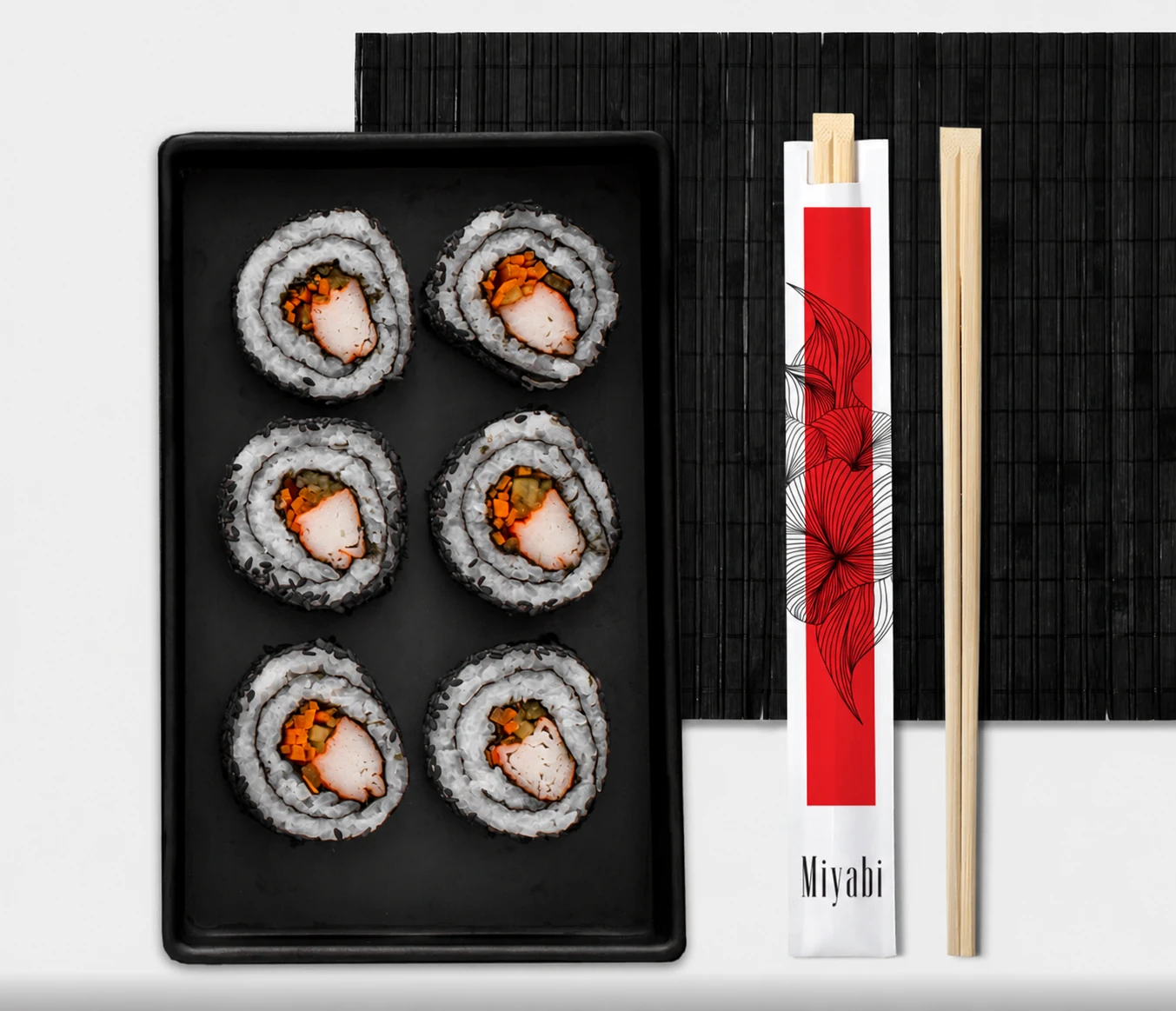Black sushi tray beside the branded Miyabi chopstick sleeve